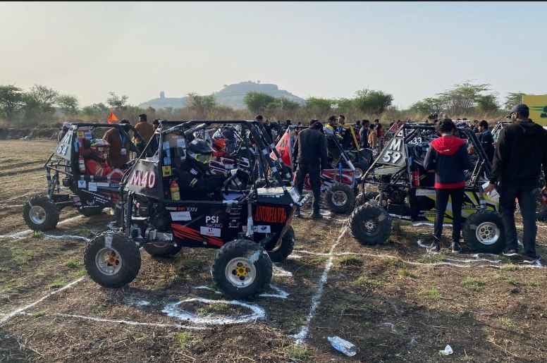 All-terrain vehicle at mBAJA 2024 with the team's car in the foreground